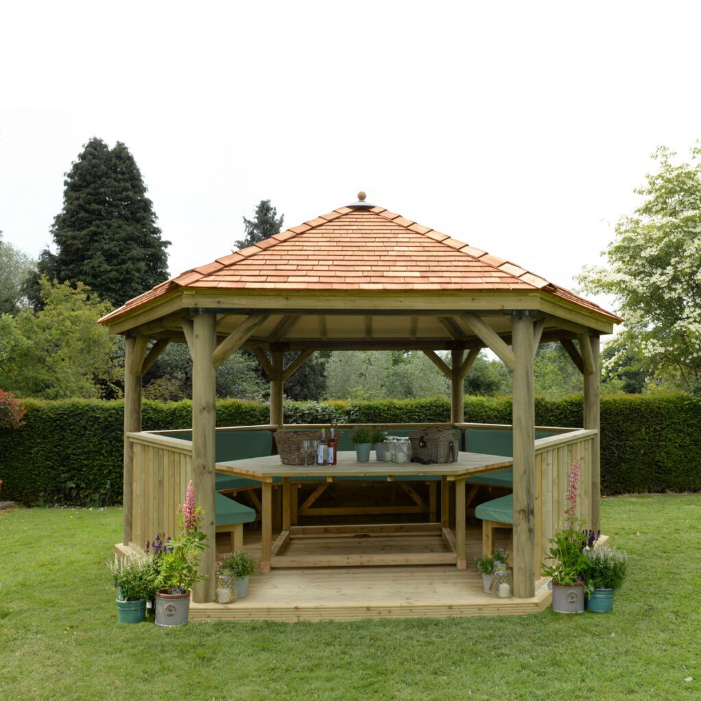 Forest Garden 4.7m Hexagonal Wooden Garden Gazebo with Cedar Roof Including Installation – Furnished with Table, Benches and Cushions  (Green) 5013053172612 2